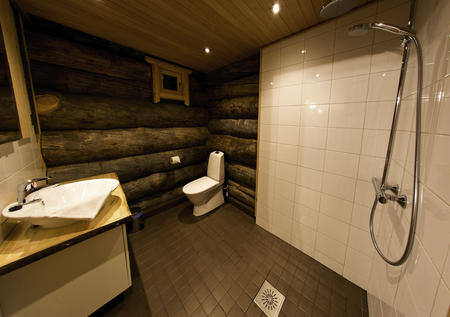Badezimmer in einer Suite im Blockhaus-Stil im Wildnishotel Nellim