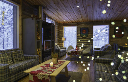 Gemütliche Sitzecke am Kamin im Haupthaus vom Wildnis-Hotel Muotka