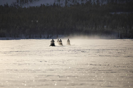Fahren Sie mit dem E-Motorschlitten über den glitzernden Schnee